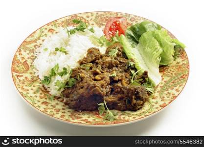North Indian or Pakistani style bhuna ghosht, a fairly dry lamb curry, served with rice and a salad