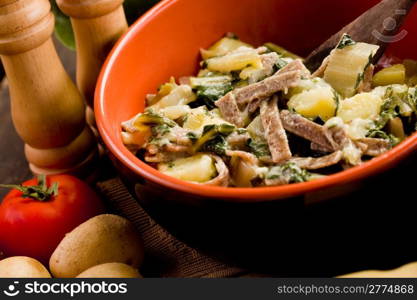 North Italian Regional pasta dish called pizzoccheri on wooden table