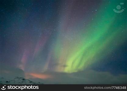 Northern Light over Iceland. Aurora Borealis on Night Sky Bachground. Magical Natural Phenomena. Tarvel to Scandinavia.. Aurora Sky Background