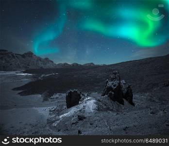 Northern lights in the mountains and plains, at night in the light of stars. aurora borealis