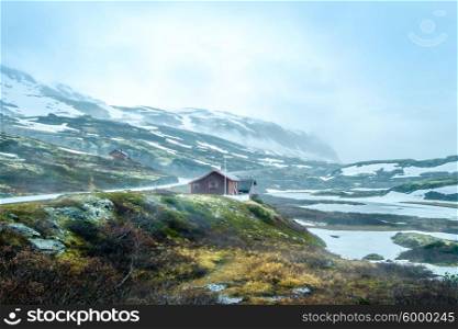 Norway landscape, a small village in inclement weather snowstorm and fog in the mountains. Beautiful Nature Norway.
