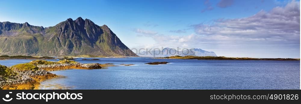 Norway landscape sunny summer panorama, fjord and mountains in the background