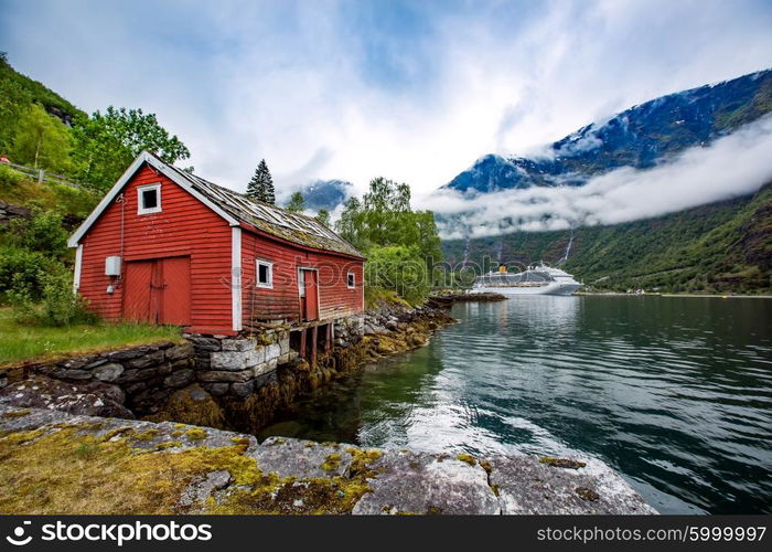 Norway landscape, the house on the shore of the fjord in the background berth cruise ship.