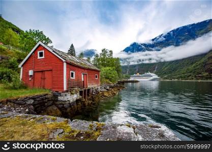 Norway landscape, the house on the shore of the fjord in the background berth cruise ship.