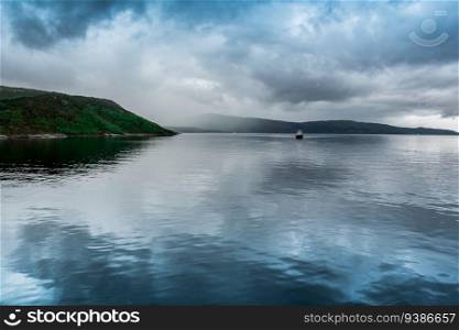 Norway landscapes. Lake, mountains on background and cloudy sky. High quality photo. Norway landscapes. Lake, mountains on background and cloudy sky