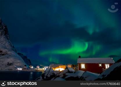 Norway. Lofoten. Norwegian village on the Hamnoy island. Winter night. Northern lights. Polar Lights in the Norwegian Village