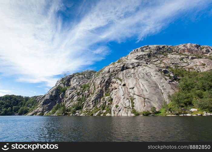 Norway, Scandinavia. Beautiful landscape on the lake shore middle of the stone mountains. blue sky