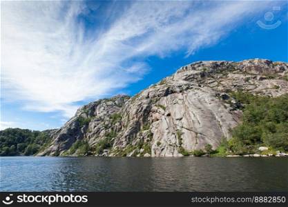 Norway, Scandinavia. Beautiful landscape on the lake shore middle of the stone mountains. blue sky