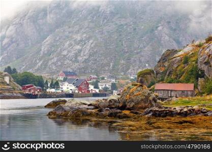Norway village on a fjord. Nordic cloudy summer day. Lofoten Norway islands.