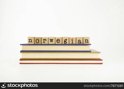 norwegain word on wood stamps stack on books, language and conversation concept