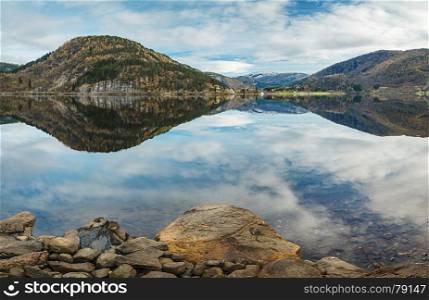 Norwegian autumn landscape a?? fjord with reflection of mountains and sky in clear water