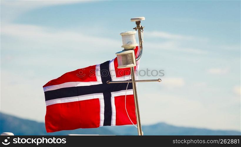 Norwegian flag on yacht ship mast, sunny day blue sky background. Norwegian flag on yacht mast