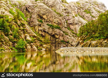 Norwegian mountains landscape. Empty road along fjord.. Road and fjord landscape in Norway