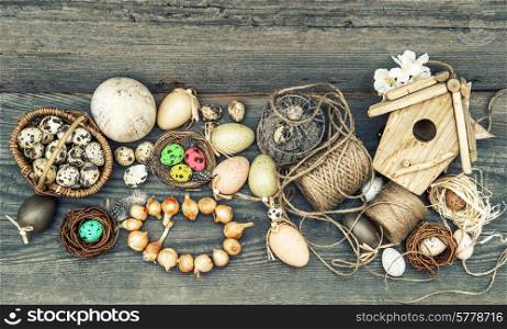 nostalgic easter stilllife home interior. vintage decoration with eggs and flower bulbs on wooden background. retro style toned picture