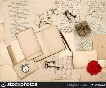 nostalgic sentimental background. old love letters, vintage accessories, diary and red rose flower