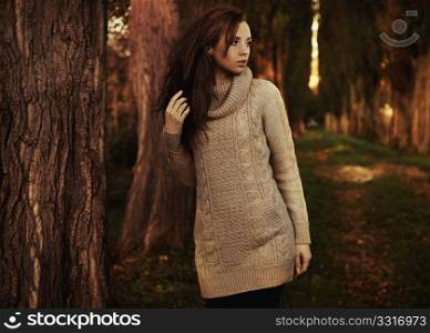 Nostalgic young woman walking in a autumn park