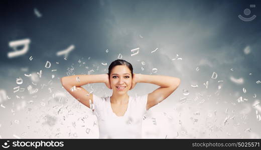 Not a sound. Young woman closing her ears with palms and enjoying the silence