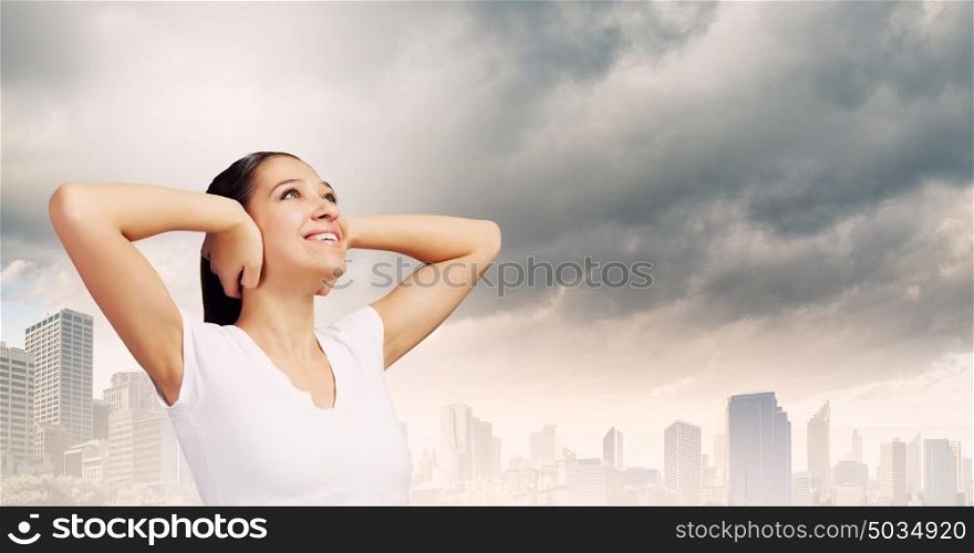 Not a sound. Young woman closing her ears with palms and enjoying the silence