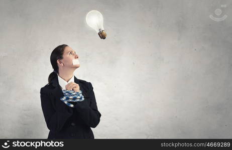 Not a word she can say. Young speechless businesswoman with tied hands and adhesive tape on mouth