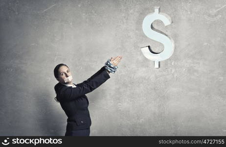 Not a word she can say. Young speechless businesswoman with tied hands and adhesive tape on mouth