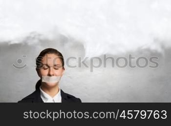 Not a word she will say. Young speechless businesswoman with adhesive tape on mouth