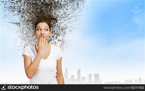 Not a word!. Young excited woman in casual closing mouth with palm