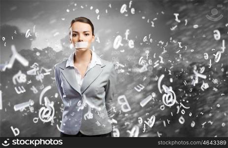 Not a word. Young speechless businesswoman with adhesive tape on mouth
