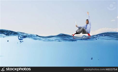 Not afraid to take risk. Young happy businessman on floating in water buoy