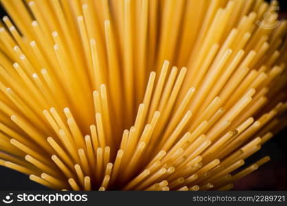 Not boiled spaghetti dry on a black background. High quality photo. Not boiled spaghetti dry on a black background.