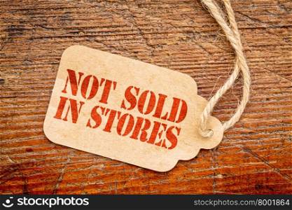 not sold in stores marketing slogan - red stencil text on a paper price tag against rustic wood