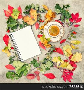Note book and cup of black coffee. Autumn background vintage style toned