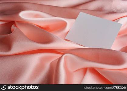 Note on beige silk. The empty paper form