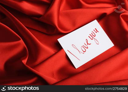 "Note on red silk. With an inscription " I love you ". Drawn by lipstick"