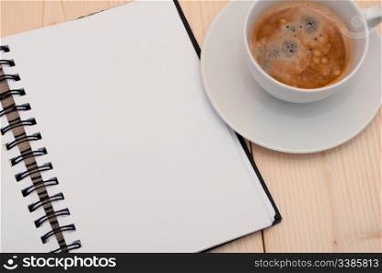 Notebook and Espresso Coffee on Wooden Table