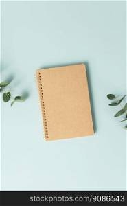 Notebook and flowers on blue background. Flat lay top view copy space. Notebook and flowers on blue background. Flat lay top view copy space mockup