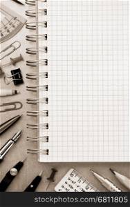 notebook and school accessories at metal background texture