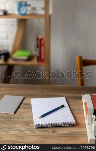 Notebook and vintage old typewriter at wooden desk table. Writer or screenwriter creative concept