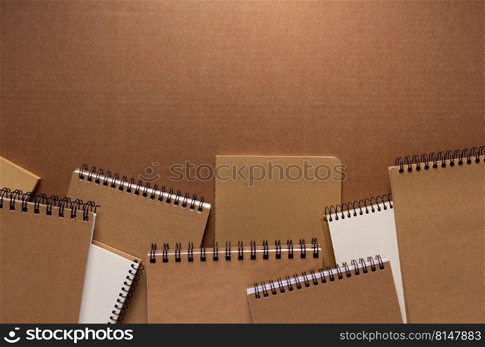 Notebook at brown paper background texture. Creative idea concept