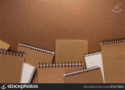 Notebook at brown paper background texture. Creative idea concept