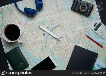 Notebook,camera,airplane,pen,calculator and map of traveler on black background with copy space .travel concept .
