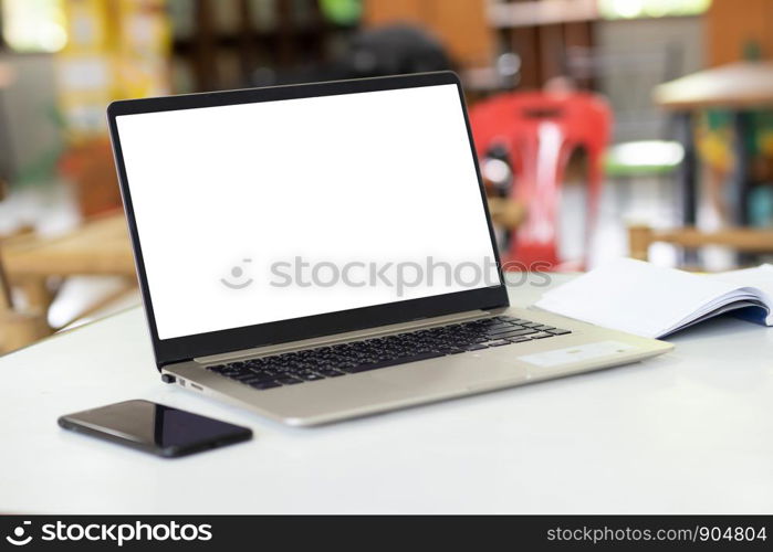 Notebook computers have a white background screen Placed on the table, blurred background