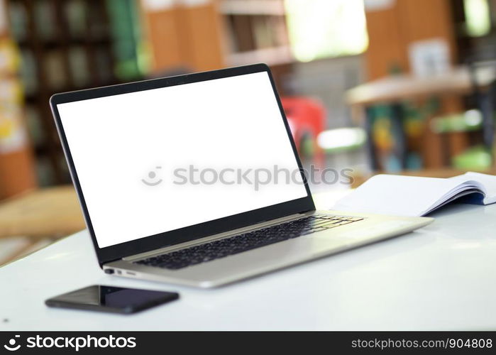 Notebook computers have a white background screen Placed on the table, blurred background