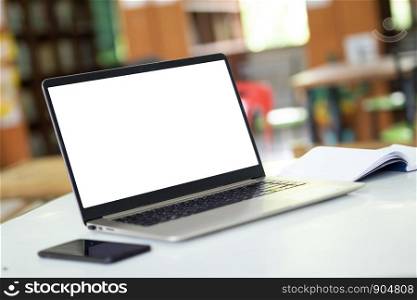 Notebook computers have a white background screen Placed on the table, blurred background