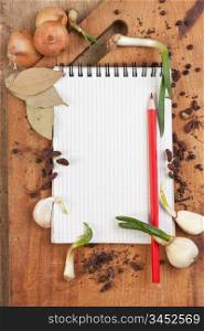 notebook for cooking recipes and spices on a wooden table