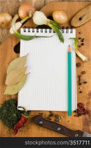 notebook for cooking recipes and spices on a wooden table