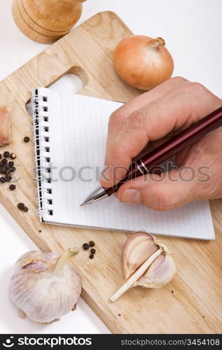 notebook for culinary recipes on a cutting board