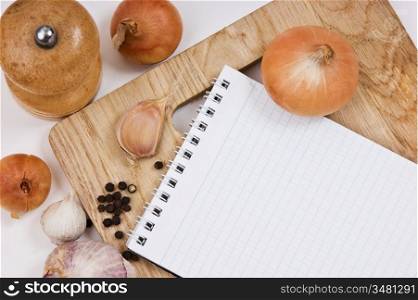 notebook for culinary recipes on a cutting board