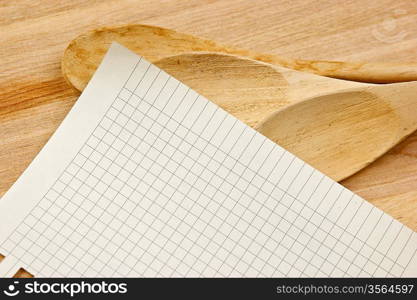 notebook for culinary recipes on a kitchen cutting board