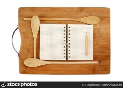 notebook for culinary recipes on a kitchen cutting board isolated on a white background