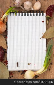 notebook for recipes and spices on an old wooden table